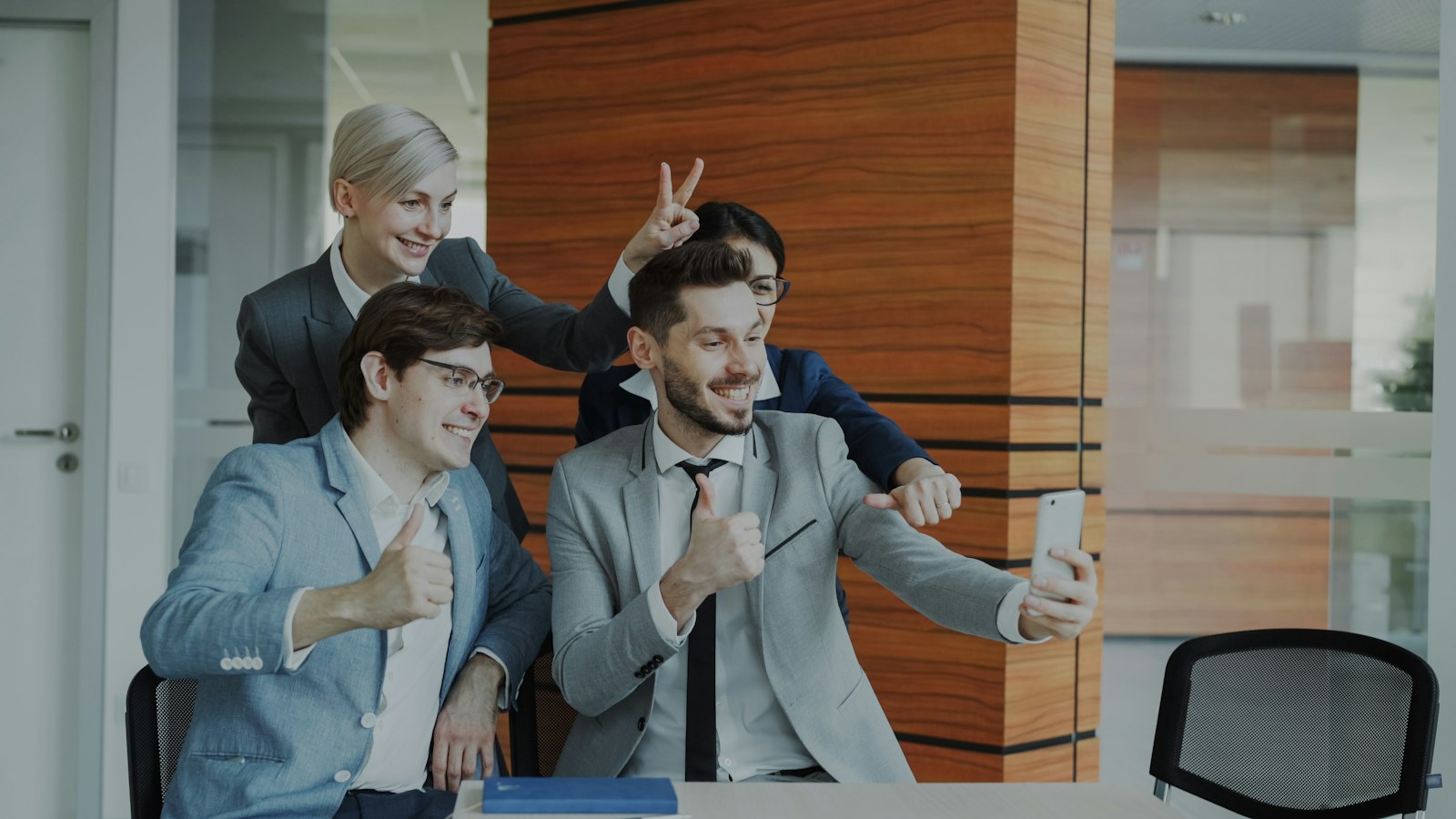 Three colleagues celebrating together in the office